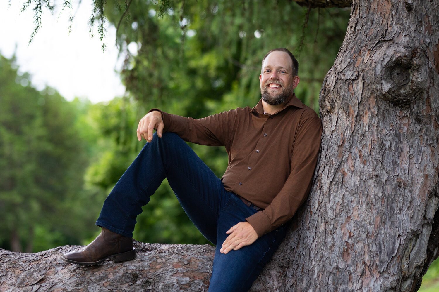 Aaron Thiessen of The Tree Daddy with a mature tree